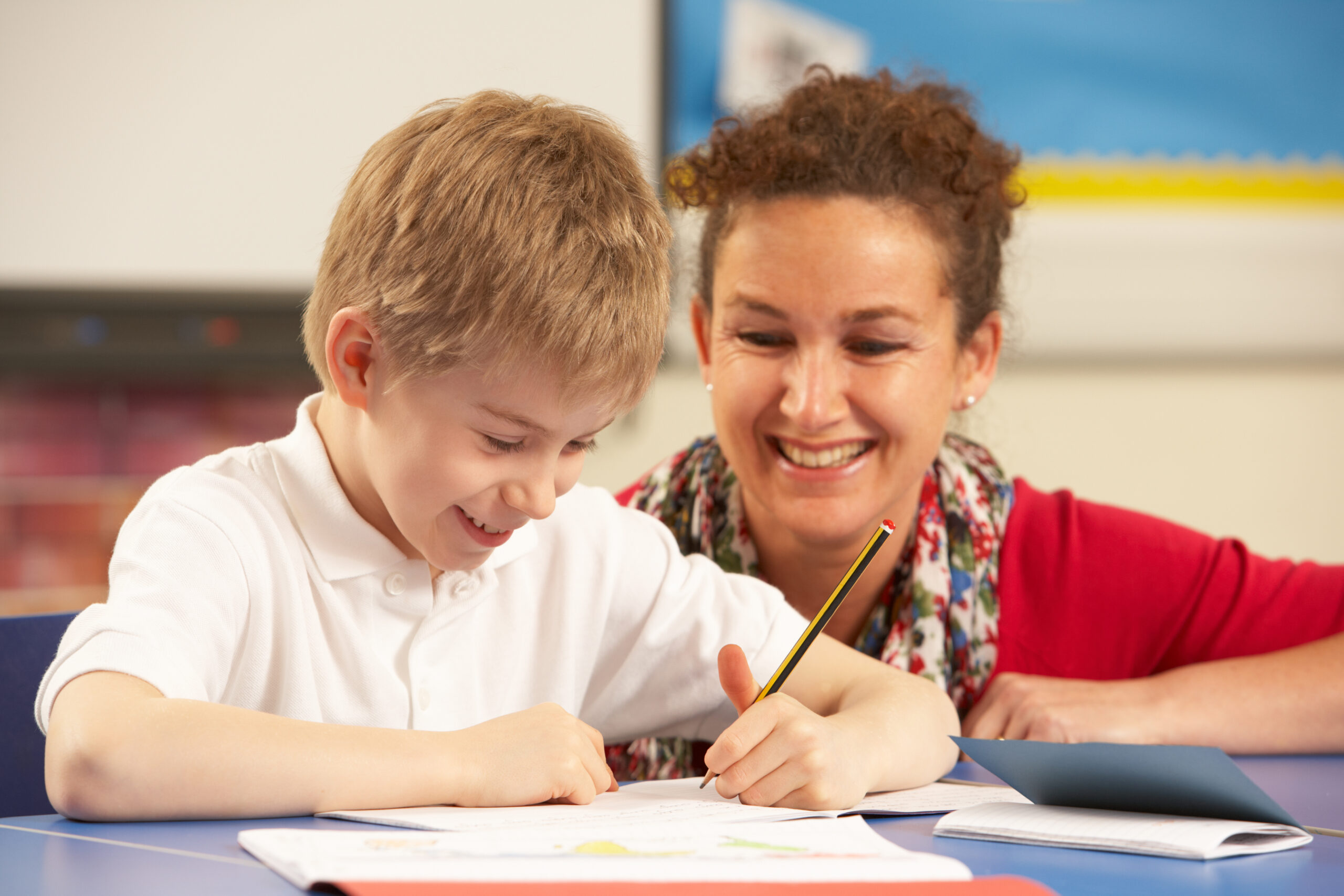 Schoolboy,Studying,In,Classroom,With,Teacher